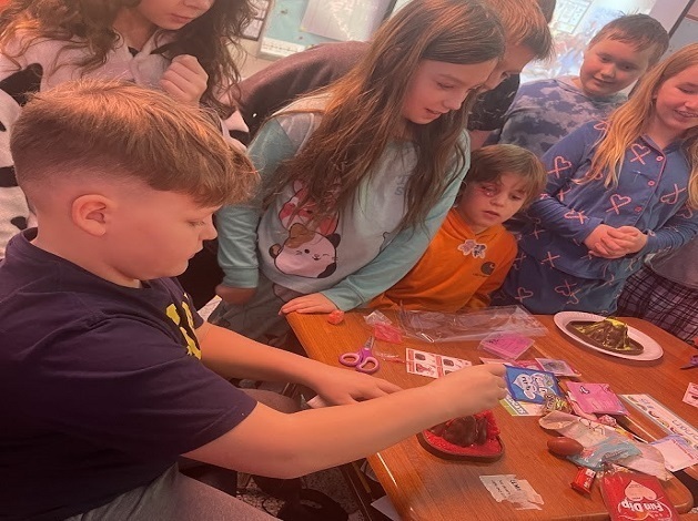 Elementary students working on a valentines day volcano project.