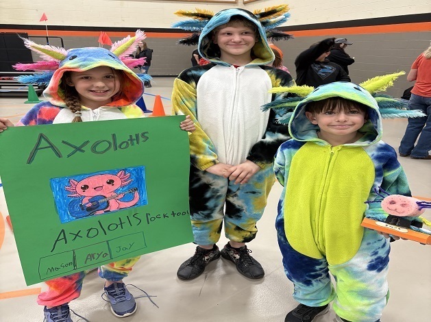 4th grade students dressed in costumes displaying their Battle Box