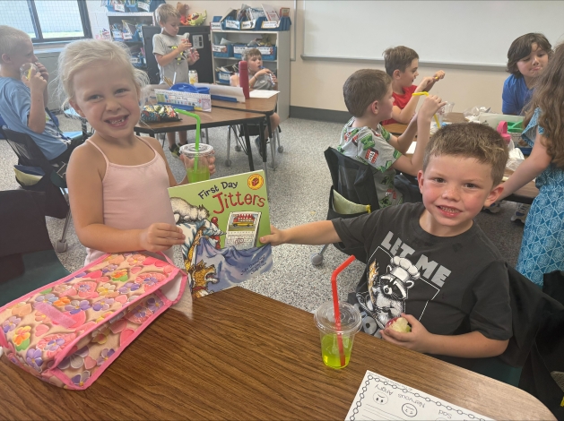 Elementary Students hold a book "First day jitters"